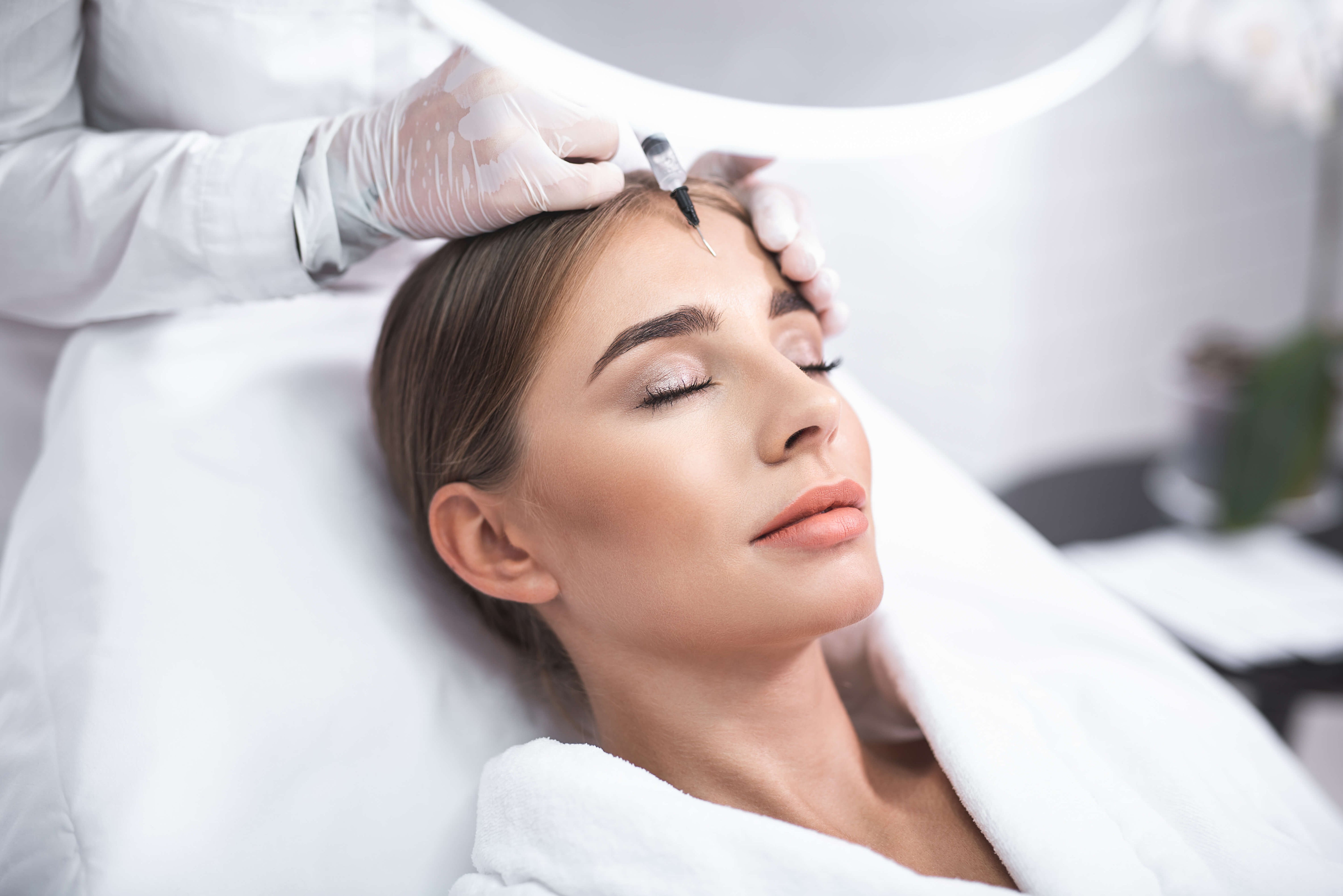 Woman receiving PRP or PRF facial treatment, promoting natural skin rejuvenation