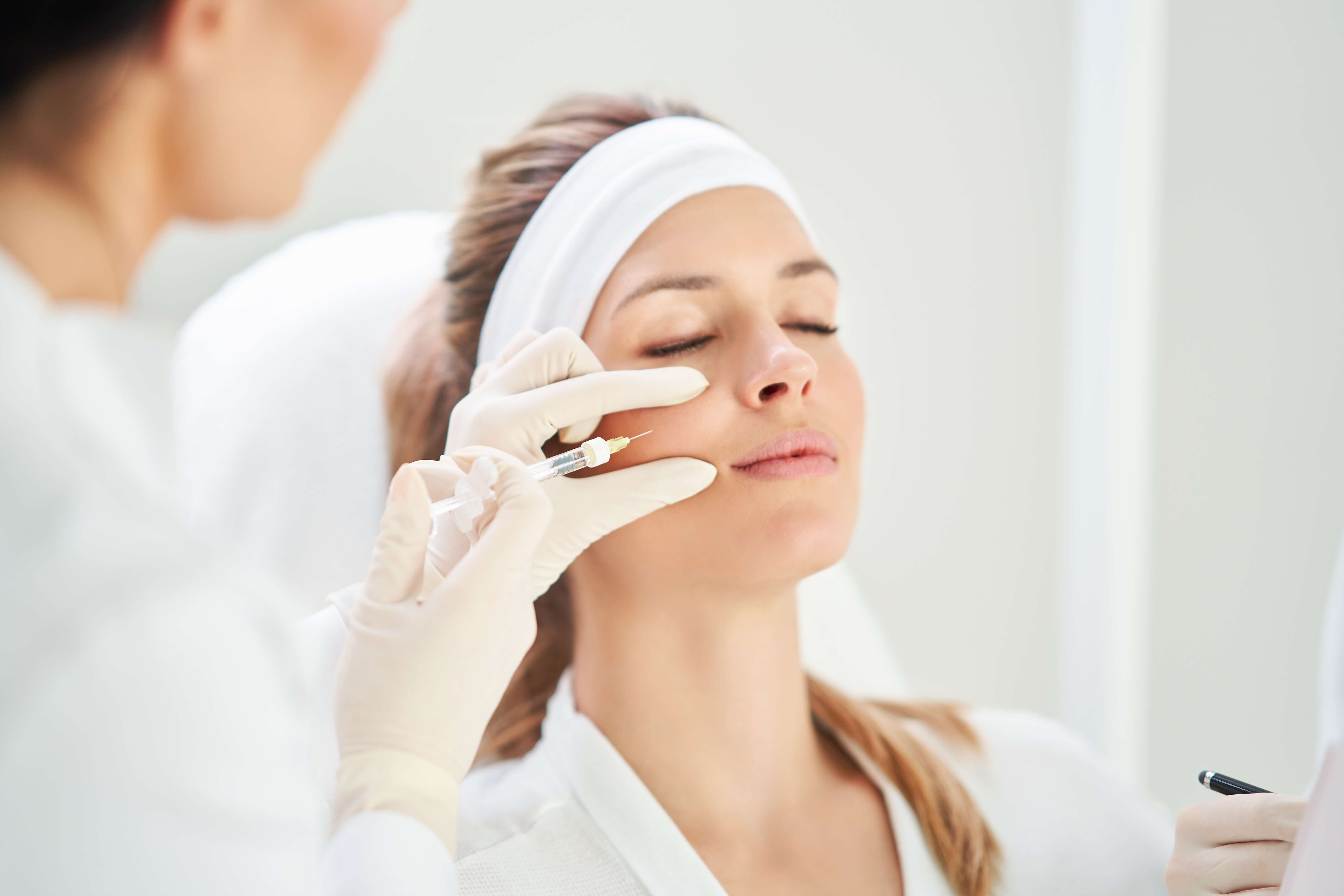 Sculptra injection being administered to the cheek area for facial volume restoration