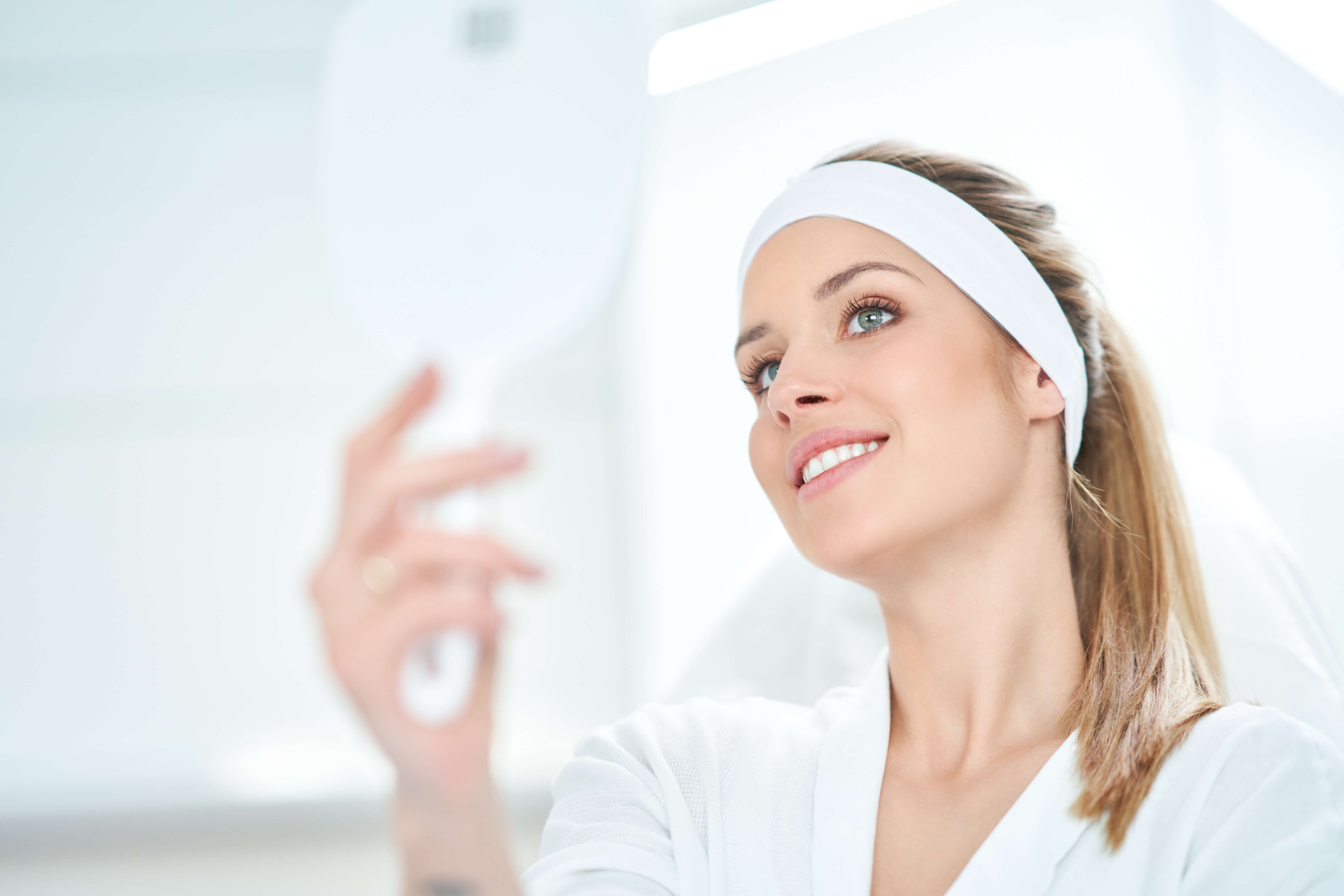 Woman with clear, glowing skin and a serene expression, representing rejuvenation and aesthetic treatments.
