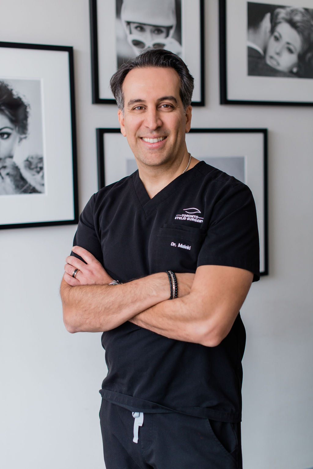 Dr. Babak Maleki in scrubs, confidently smiling at the clinic, representing trust, expertise, and personalized care