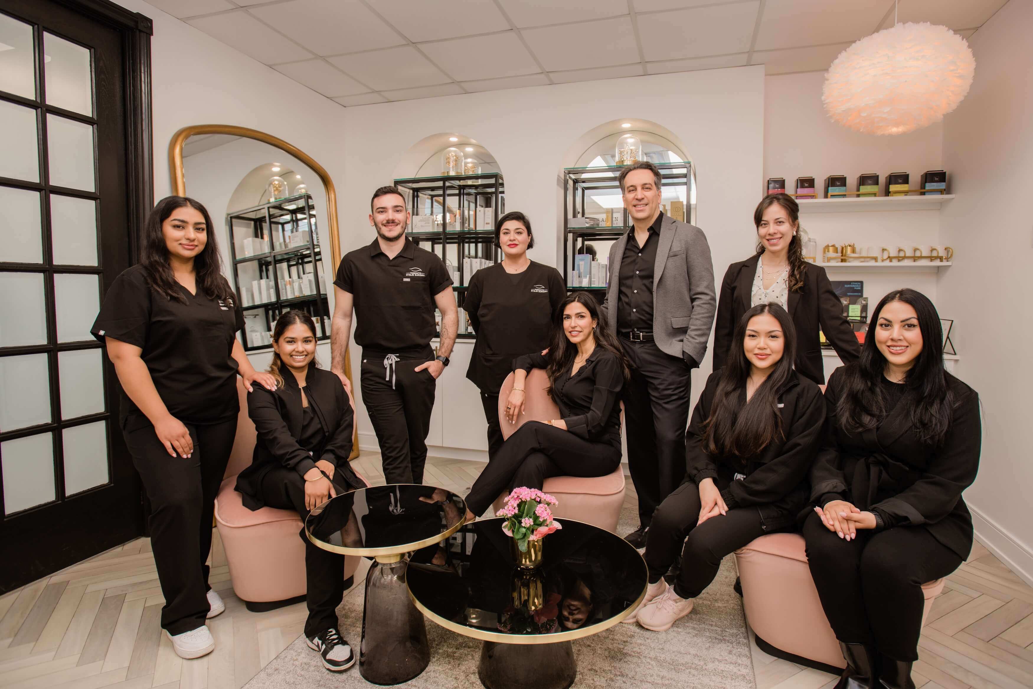 Dr. Babak Maleki and the clinic team posing together in a modern, elegant setting — warm, professional, and welcoming atmosphere