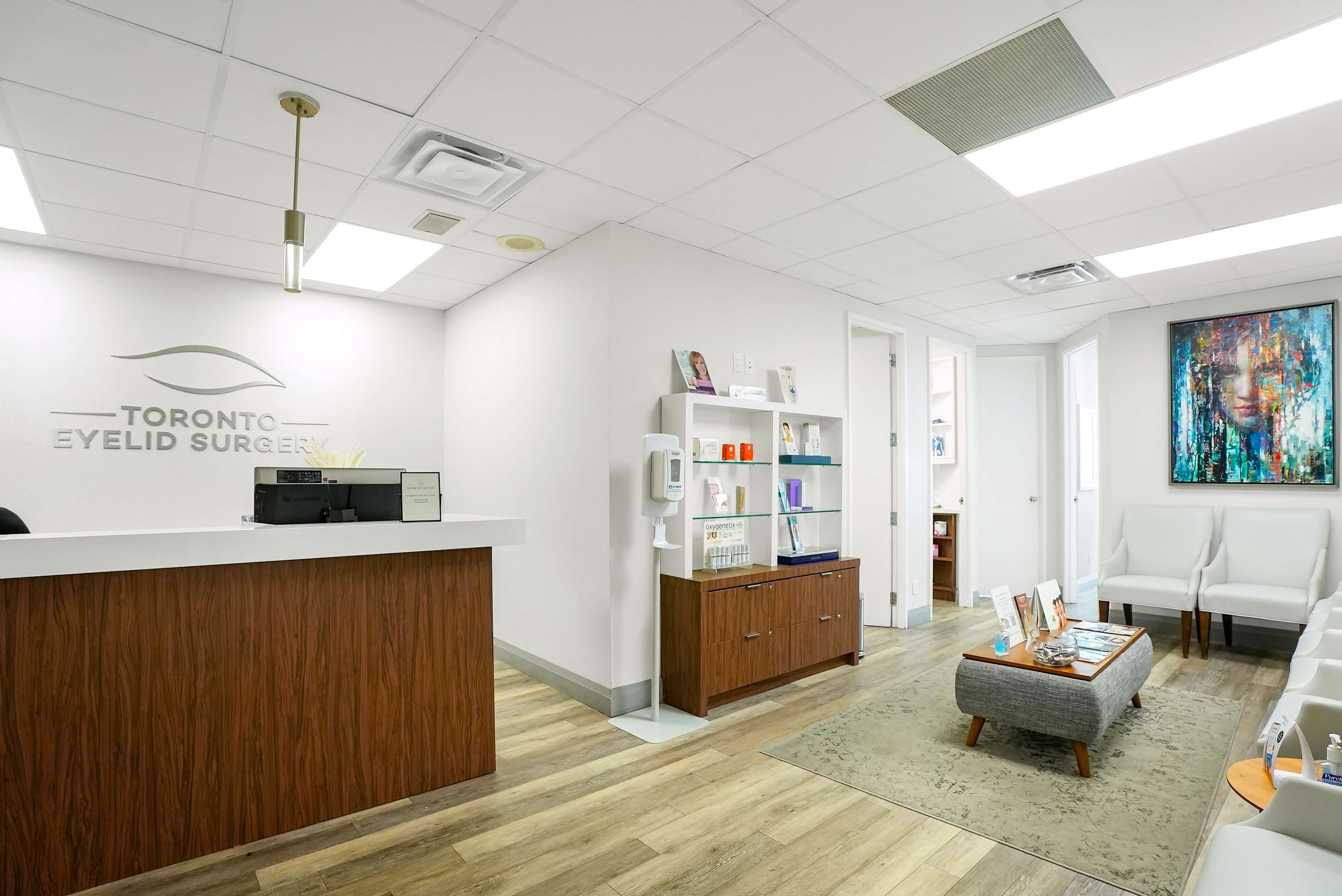 Reception area of Toronto Eyelid Surgery clinic with modern design, wood accents, and welcoming waiting lounge